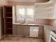 An updated kitchen features light countertops, new appliances, bright light, and open shelving at 704 S Ohio St, Sheridan, IN 46069