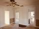 Living room featuring original trim work and a ceiling fan with vintage accents and a view to the kitchen at 704 S Ohio St, Sheridan, IN 46069
