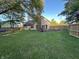 Lush backyard with expansive green lawn, a privacy fence, and an outdoor seating area at 8104 Pocket Hollow Ct, Indianapolis, IN 46256