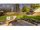 Lush backyard features a wooden bench on a patio, providing a serene outdoor retreat at 8104 Pocket Hollow Ct, Indianapolis, IN 46256
