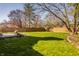 Spacious backyard featuring a well-manicured lawn, a wood fence, and mature trees at 8104 Pocket Hollow Ct, Indianapolis, IN 46256