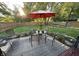 Inviting backyard patio with umbrella, table and chairs perfect for relaxing or entertaining at 8104 Pocket Hollow Ct, Indianapolis, IN 46256