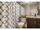 Practical bathroom with a white toilet, a pattern shower curtain and dark wood cabinets at 8104 Pocket Hollow Ct, Indianapolis, IN 46256