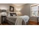Comfortable bedroom with a well-lit window and stylish lamps on a wooden floor at 8104 Pocket Hollow Ct, Indianapolis, IN 46256
