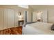 Bright bedroom featuring hardwood floors, white closets, and a cozy bed with soft textures at 8104 Pocket Hollow Ct, Indianapolis, IN 46256