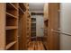 Spacious walk-in closet with custom wood shelving and plenty of storage for organization at 8104 Pocket Hollow Ct, Indianapolis, IN 46256