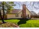 Exterior home view featuring a large backyard and patio area at 8104 Pocket Hollow Ct, Indianapolis, IN 46256