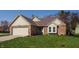 Inviting home featuring a brick facade, two-car garage, and manicured front lawn at 8104 Pocket Hollow Ct, Indianapolis, IN 46256