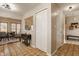 Open hallway leading to dining area featuring natural lighting and closet space at 8104 Pocket Hollow Ct, Indianapolis, IN 46256