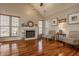 Elegant living room with hardwood floors, fireplace, and natural light from large windows at 8104 Pocket Hollow Ct, Indianapolis, IN 46256