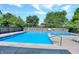 Community pool surrounded by lounge chairs offers a refreshing outdoor escape for residents at 8104 Pocket Hollow Ct, Indianapolis, IN 46256