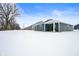 Rear view of a blue house with a covered porch in a snowy landscape at 829 Stark St, Greenfield, IN 46140