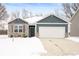 Newly built home with gray siding, stone accents, and a two-car garage at 829 Stark St, Greenfield, IN 46140