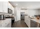 Modern kitchen with white cabinets, stainless steel appliances, and an island at 829 Stark St, Greenfield, IN 46140