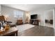 Living room with leather couch, TV stand and hardwood floors at 829 Stark St, Greenfield, IN 46140