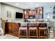 Basement wet bar with granite countertop and custom cabinetry at 8526 Oakmont Ln, Indianapolis, IN 46260