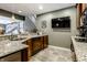 L-shaped basement bar with granite countertops and stainless steel appliances at 8526 Oakmont Ln, Indianapolis, IN 46260