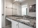 Bathroom with granite countertop, white cabinets, and a single sink at 8526 Oakmont Ln, Indianapolis, IN 46260