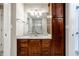 Bathroom with granite countertop, dark brown cabinets, and a single sink at 8526 Oakmont Ln, Indianapolis, IN 46260