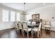 Bright dining room with hardwood floors, stylish table and chairs, and large windows at 8526 Oakmont Ln, Indianapolis, IN 46260
