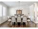 Formal dining room with a large table and chairs, hardwood floors and a statement chandelier at 8526 Oakmont Ln, Indianapolis, IN 46260