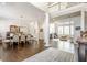 Elegant dining room features a large table, chandelier, and hardwood floors, view to living room at 8526 Oakmont Ln, Indianapolis, IN 46260