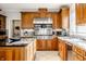 Open kitchen with granite countertops, stainless steel appliances and custom cabinetry at 8526 Oakmont Ln, Indianapolis, IN 46260
