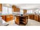 Large kitchen island with granite countertop and wooden base cabinets at 8526 Oakmont Ln, Indianapolis, IN 46260