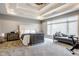 Spacious main bedroom with coffered ceiling, plush carpet, and seating area at 8526 Oakmont Ln, Indianapolis, IN 46260
