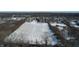 Aerial view of property with snow-covered field and residential neighborhood in background at 868 N Raceway Rd, Indianapolis, IN 46234