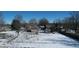 Aerial view of house and backyard with snow-covered lawn and surrounding trees at 868 N Raceway Rd, Indianapolis, IN 46234