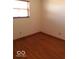 Spacious bedroom with hardwood floors and a large window at 868 N Raceway Rd, Indianapolis, IN 46234