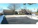 Brick house with three-car garage, and a snow covered front yard at 868 N Raceway Rd, Indianapolis, IN 46234