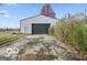 Detached garage with large door and paved driveway at 868 N Raceway Rd, Indianapolis, IN 46234