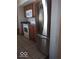 Kitchen features stainless steel refrigerator and wood cabinets at 868 N Raceway Rd, Indianapolis, IN 46234