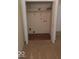 Well-lit laundry room with built-in shelving and vinyl flooring at 868 N Raceway Rd, Indianapolis, IN 46234