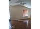 Living room with hardwood floors, window with blinds, and ceiling fan at 868 N Raceway Rd, Indianapolis, IN 46234