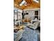 Bright sunroom features vaulted ceiling, brick wall, and comfortable seating at 868 N Raceway Rd, Indianapolis, IN 46234
