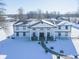 Aerial view of a two-story home with a large covered porch and expansive snowy yard at 881 E 226Th St, Sheridan, IN 46069