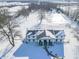 Aerial view showcasing a home with a pond, snowy landscape, and a spacious backyard at 881 E 226Th St, Sheridan, IN 46069