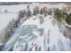 Aerial view of property showing home, pond, and expansive snowy landscape at 881 E 226Th St, Sheridan, IN 46069