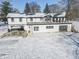 Home's back with a large deck, attached garage, and snowy surroundings at 881 E 226Th St, Sheridan, IN 46069