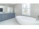Elegant bathroom with double vanity, soaking tub, and large window at 881 E 226Th St, Sheridan, IN 46069
