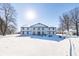 Stunning two-story home with a snow covered front yard at 881 E 226Th St, Sheridan, IN 46069