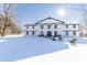 Two story home with white siding and black accents in winter setting at 881 E 226Th St, Sheridan, IN 46069