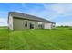 Spacious backyard featuring a lush lawn and the home's exterior, and a white fence at 9711 Palermo Ave, Indianapolis, IN 46239