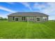 Wide shot of the home exterior, expansive backyard, and new privacy fence at 9711 Palermo Ave, Indianapolis, IN 46239