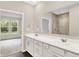 Bright bathroom featuring a double sink vanity and view of a glass shower at 9711 Palermo Ave, Indianapolis, IN 46239