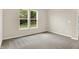 Bright bedroom with neutral walls, plush carpeting, and natural light from large windows at 9711 Palermo Ave, Indianapolis, IN 46239