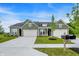 Charming single-story home featuring a three-car garage, green lawn, and well-maintained landscaping at 9711 Palermo Ave, Indianapolis, IN 46239